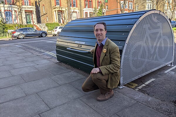 Cllr Matthew Kirk with cycle hangar